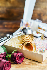 gift set for ice cream in a box: waffle cups, spoon for ice cream, sprinkles and topping