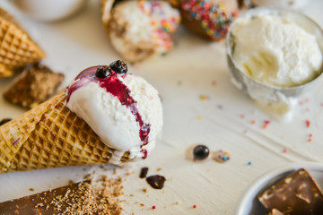 A Kit For Making Ice Cream: Spoon For Ice Cream, Ice Cream Cones, Jam, Topping, Chocolate, Sprinkles, Coconut Shavings. on white background. Concept Ideas For A Gift With Their Own Hands.