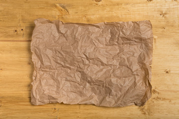 wrinkled paper on wooden background