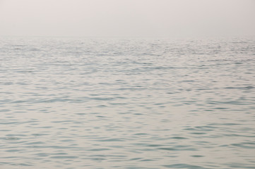 Fototapeta premium Black Sea. Water with no waves. Calm. Mainly cloudy weather. Blue and grey clouds. Before rain