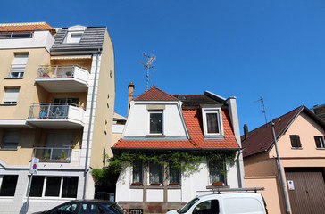 small house next to small apartment building