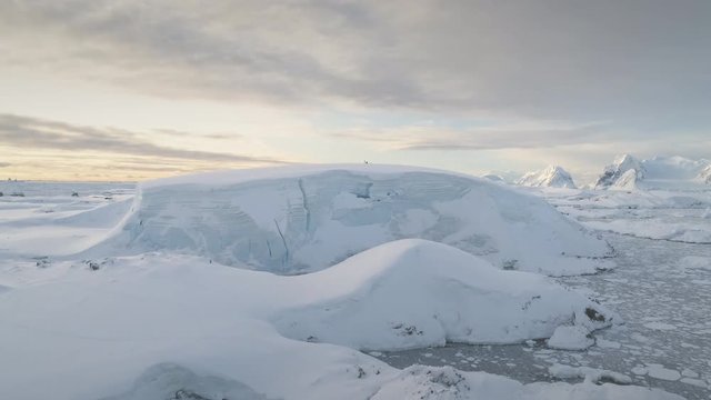 Antarctica Snow Hill Aerial Drone View. Climate Change. Antarctic Continent Expedition at Ocean Coastline. Polar Landscape. Global Warming and Melting Ice Concept. Top Flight Footage Shot in 4K (UHD)