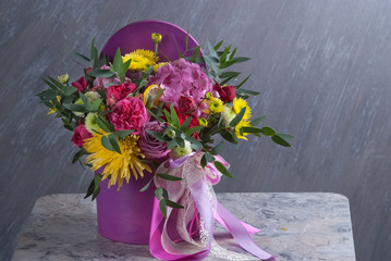 bouqet of flowers in violet box. Nice celebration present. Selective focus, close up
