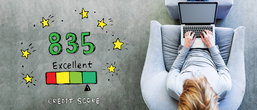 Excellent credit score theme with man using a laptop in a modern gray chair
