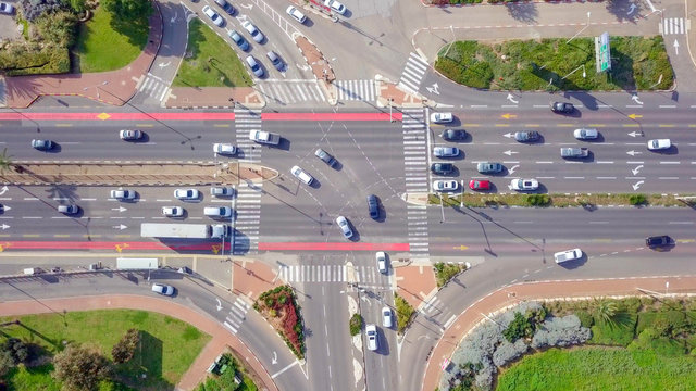 Top down aerial image of traffic on a busy Junction with cars and trucks.