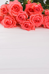 Bouquet of red roses on white wooden table. Copyspace, free space for text.