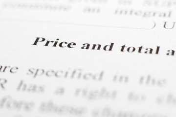 A fragment of the contract with the terms of price increase. Macrophoto conditions about price and total cost close up. The buyer and the seller made a contract on paper. Selective focus.