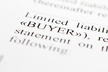 Fragment of a contract printed on paper. Macrophoto Word Buyer Closeup. The buyer and the seller made a contract on paper. Selective focus.