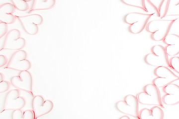 Wreath frame made of paper heart symbols on white background. Flat lay, top view Valentines Day background love concept.