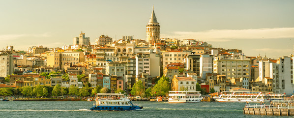 Istanbul waterfront, Turkey. Beyoglu district with the old famous Galata Tower.  Panoramic sunny...