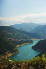 Naklejka na ściany i meble Stunning views from the top of the mountains, the valley and the man-made reservoir in Montenegro.