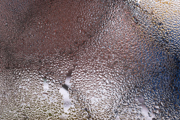 Water drops on glass window close up with blurred background. Drops in macro. Condensate on window...