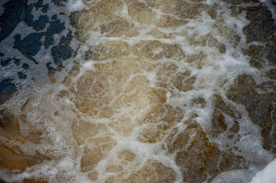 Waterfalls in summer. Clear and fresh water are falling down. Tints of green, blue and white. There are grey stones inside. Fotography made with short time-exposure 