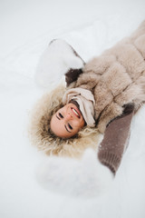 Photo of blonde lying in snow on walk