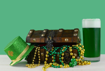 Image for Saint Patrick's Day on March 17th. Treasure chest to symbolize luck and wealth. A glass...