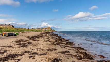 North Sea Coast in Boulmer in Northumberland, England, UK - with some barrels on the beach