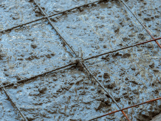 Steel wire mesh laying on concrete mix
