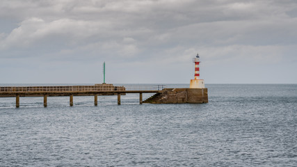 Fototapeta premium The Pier Lighthouse in Amble in Northumberland, England, UK, seen from the South Pier