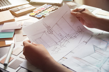 Architect designer Interior creative working hand drawing sketch plan blue print selection material...