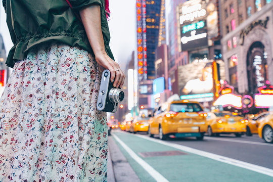 Young girl with a retro camera in New York City