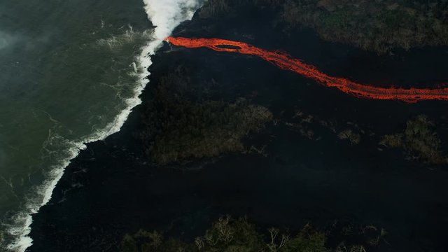 Aerial view red hot lava pouring into Pacific