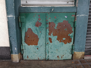 worn rusty metal door at a bar