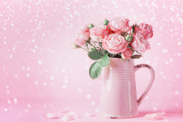 Beautiful rose flowers in pink vase for Womens day or Mothers day greeting card.