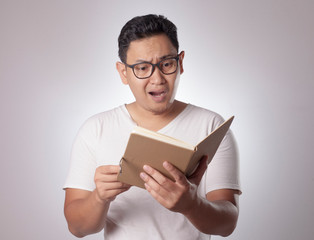 Happy Man Smiling While Reading Book