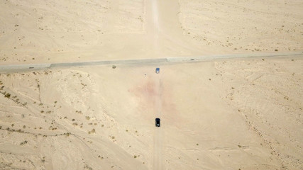 Two Off-road vehicles on desert road - Aerial image
