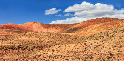 Amazing view of sandy desert at high Atlas mountains range. Moroccan landscapes with bright sun and clear blue sky. View of the desolating valley mountains. Beautiful Northern African Landscape