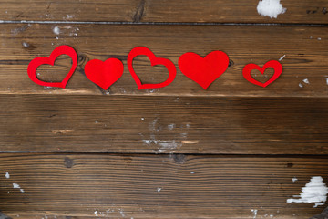 Red paper Valentine hearts on wooden background. Valentine's day gift.