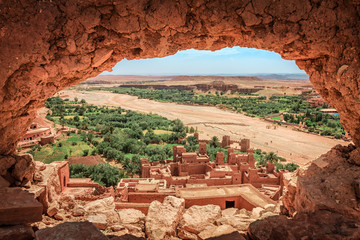 Popular point of view of the valley of the desolating river Onila through a hole in a wall of Ancient Kasbah in Ait-Ben-Haddou, Morocoo. Famous ancient berber kasbah. near Ouarzazate city in Morocco