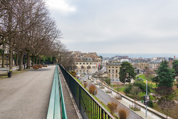 Top view from Place de jeux de la promenade de la Treille,  Geneva's oldest promenade near old town, with green longest bench in the world and lower Geneva town.