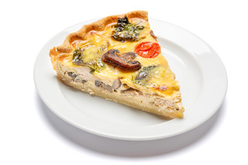 Slice of traditonal homemade spinach chicken quiche tart or pie on plate