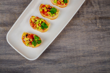 Sandwich with bread, avocado, tomato on wooden board
