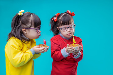 Curious twin sisters with mental disorder examining holiday cakes