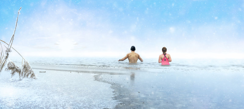 Man and woman going ice swimming