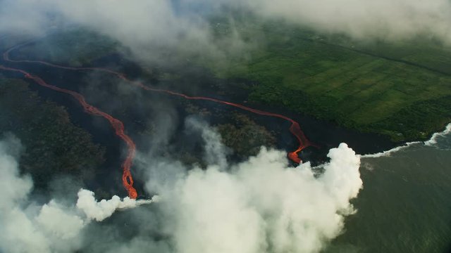Aerial view red hot lava pouring into Pacific