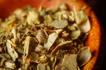 Dried oregano spice in a spoon. Extreme macro photography.
