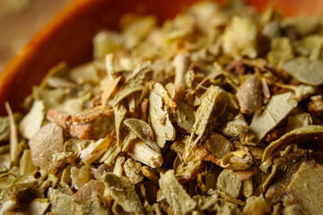 Dried oregano spice in a spoon. Extreme macro photography.