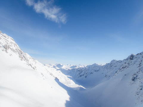 View of the Alpine mountain range from the top of the Parpaner Rothorn in Switzerland 