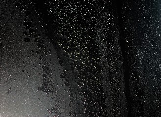 Naklejka na ściany i meble Water droplets on black background