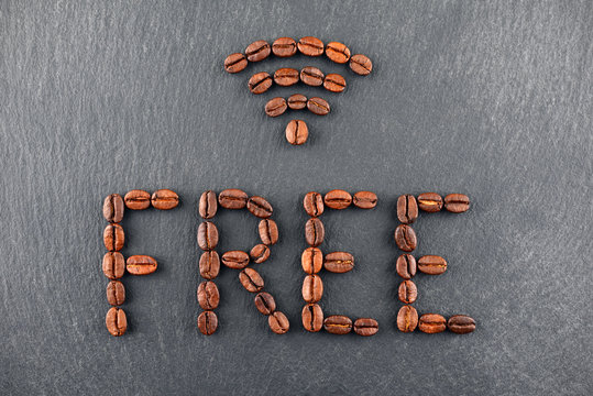 Sign of free Wifi made with coffee beans on a dark background.