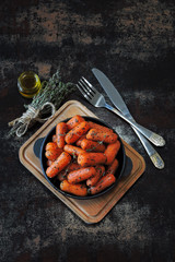 Baked baby carrots in a cast iron skillet. Vegan dinner.