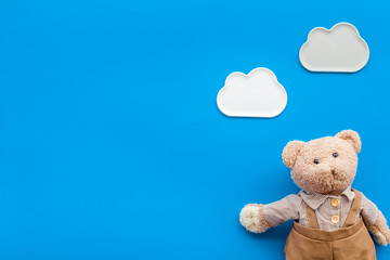 Craft toys for kids. Handmade teddy bear. Blue background top view mock up