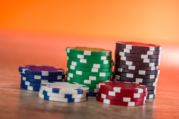 Poker chips on wooden desk, gambling concept
