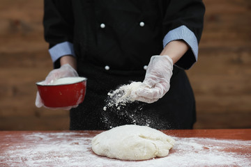 the cook makes flour for baking on the table