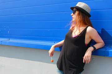 Girl hipster in a light hat and sunglasses on a summer