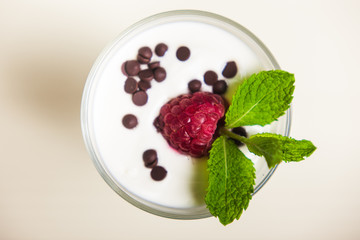 Yogurt with cream, raspberries served in glass