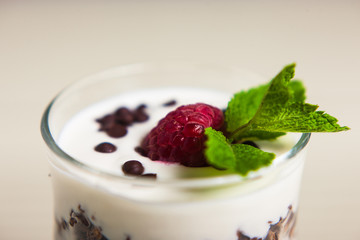 Yogurt with cream, raspberries served in glass
